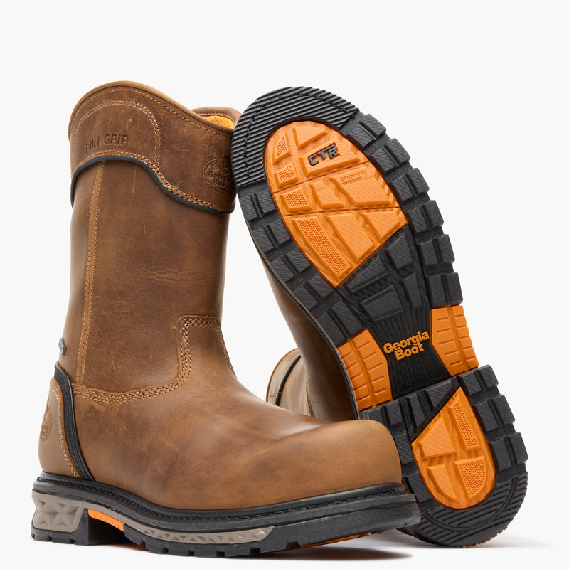 Brown work boot with orange and black sole on a white background