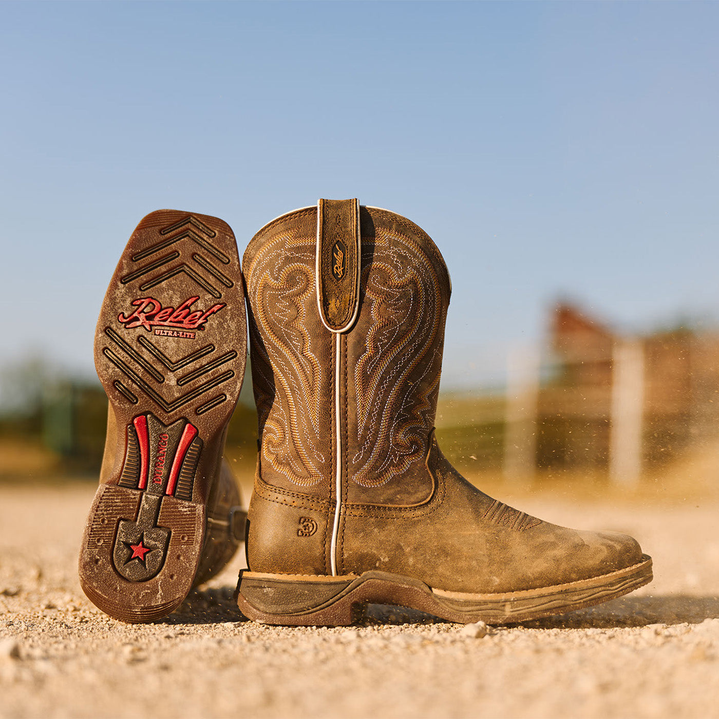 Women's Durango Rebel Ultra lite western boot in Texas on a gravel road with outsole showing
